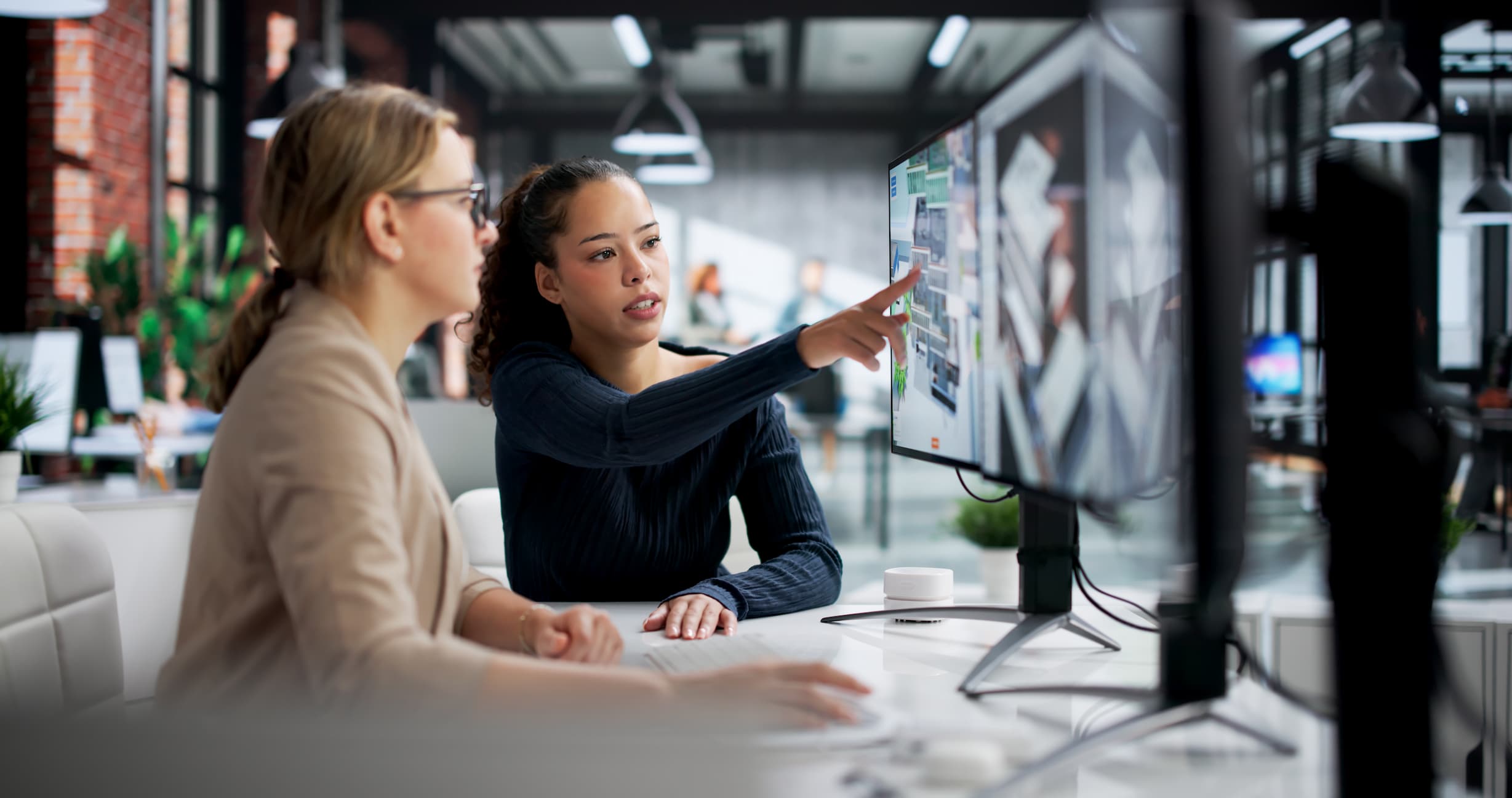 two engineers using 3D GIS software to analyze data