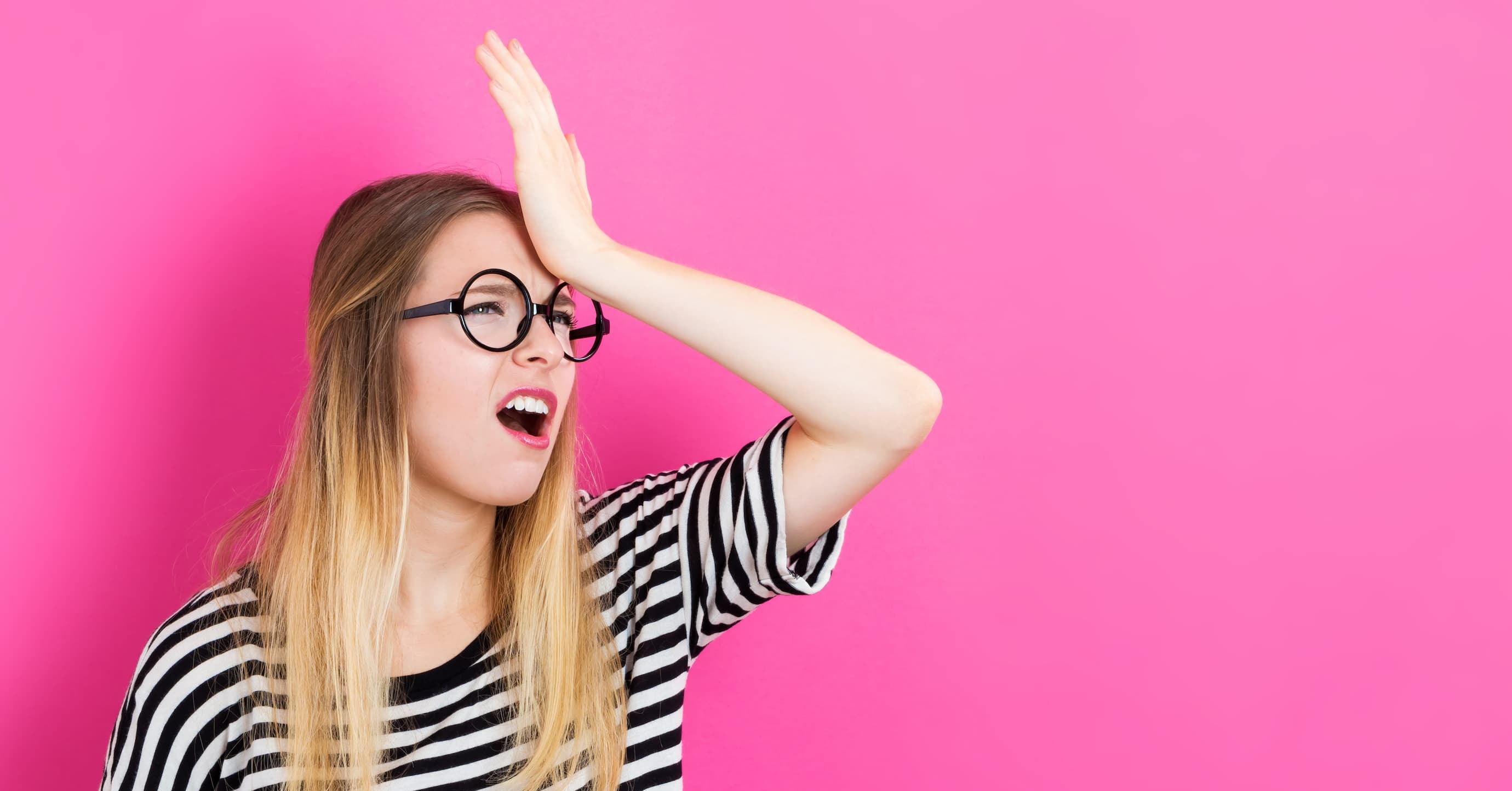a woman smacking her forehead, representing forgetting something