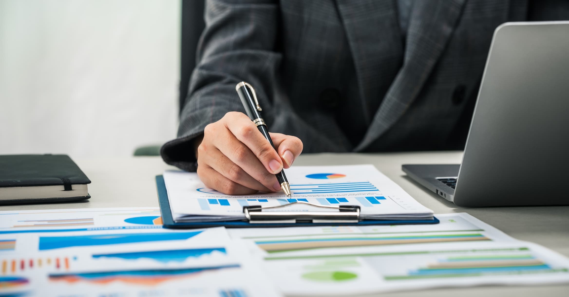 a person writing notes on a printed graph