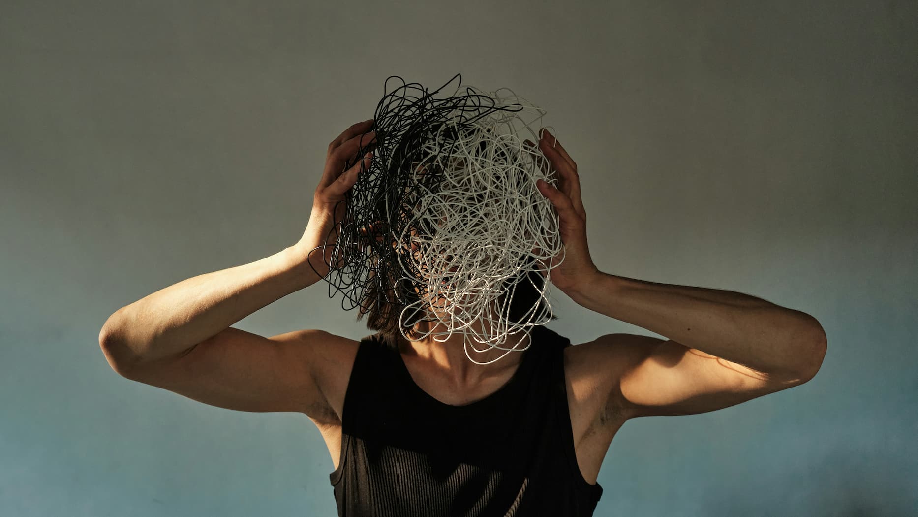 a person with tangled wires over their face, representing messy data