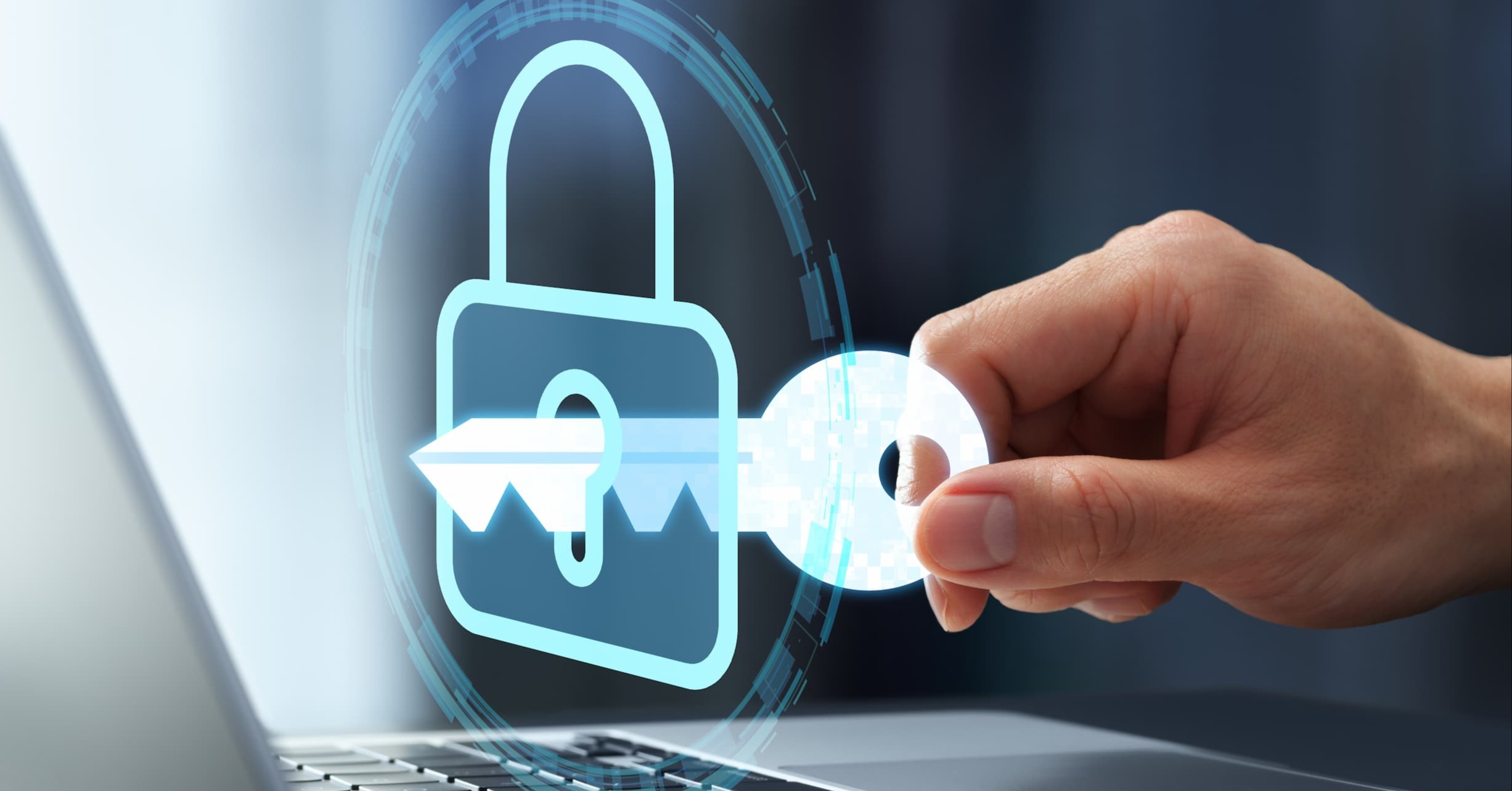 illustration of a key opening a lock, hovering over a laptop. representing software access. 
