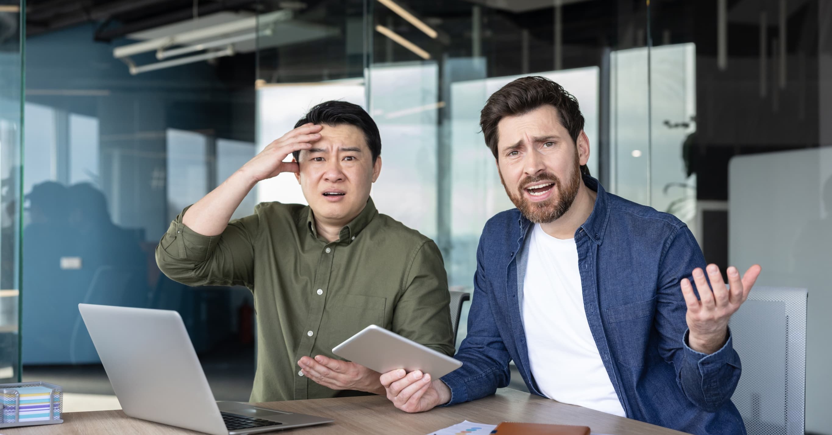 two frustrated employees gesticulating 